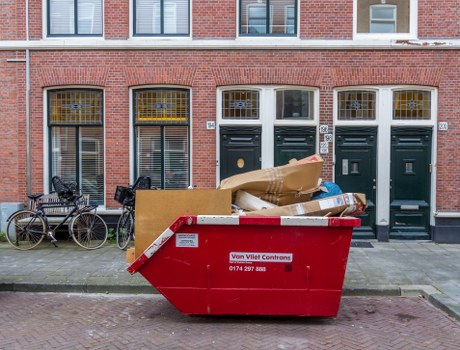 Enclosed and lockable skip placed in a Gunnersbury residential area