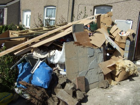 Eco-friendly commercial skip placed at a retail store in Gunnersbury